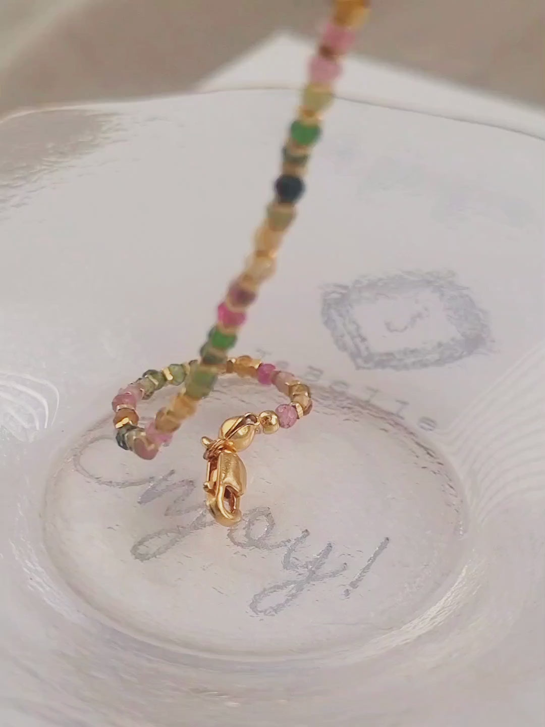 Close-up of a boho-chic beaded bracelet featuring natural tourmaline and gold plated beads. Perfect gift for her.
