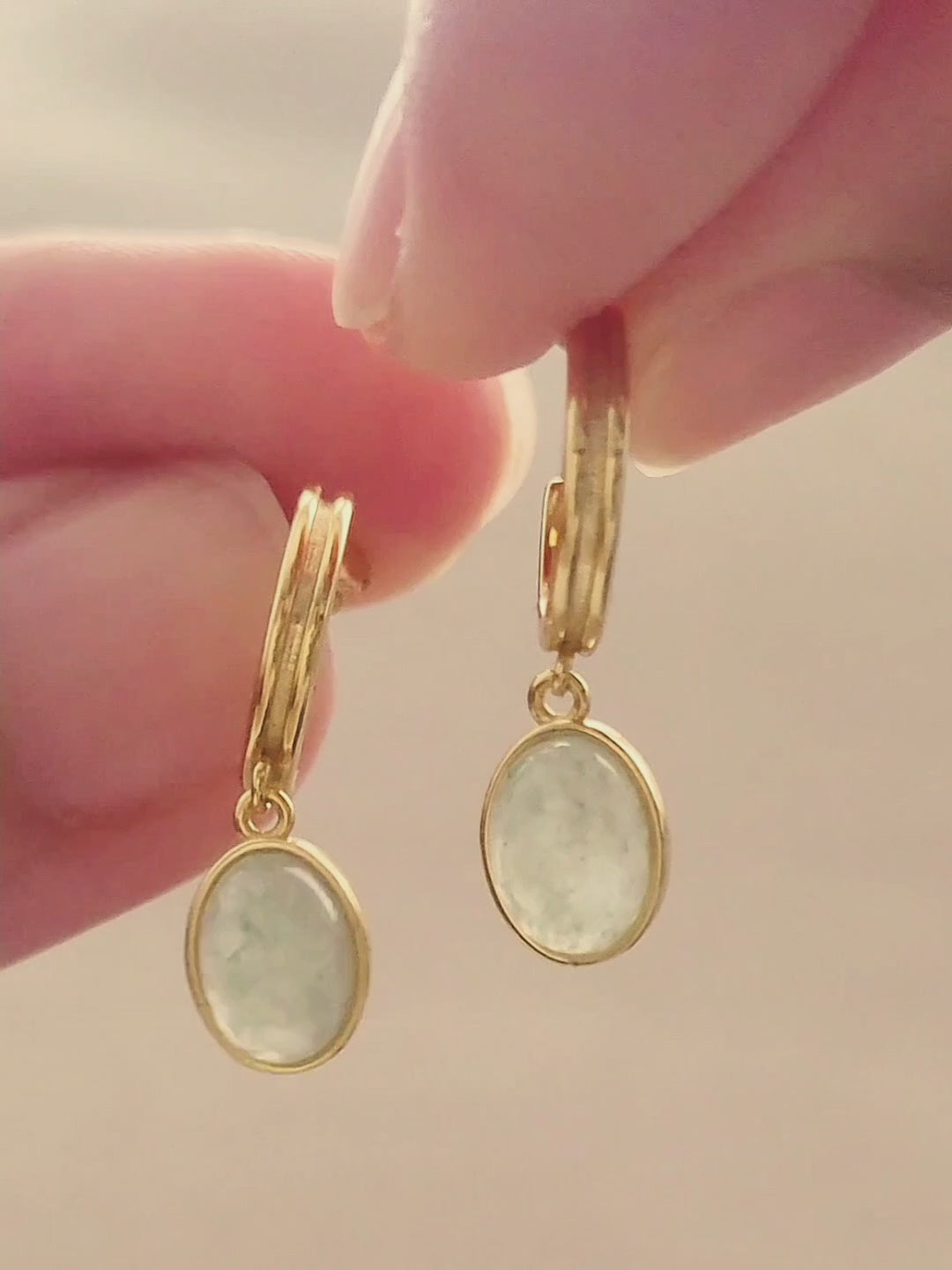 A woman displays a stunning gold aventurine drop earrings, emphasizing the charm of natural gemstones.