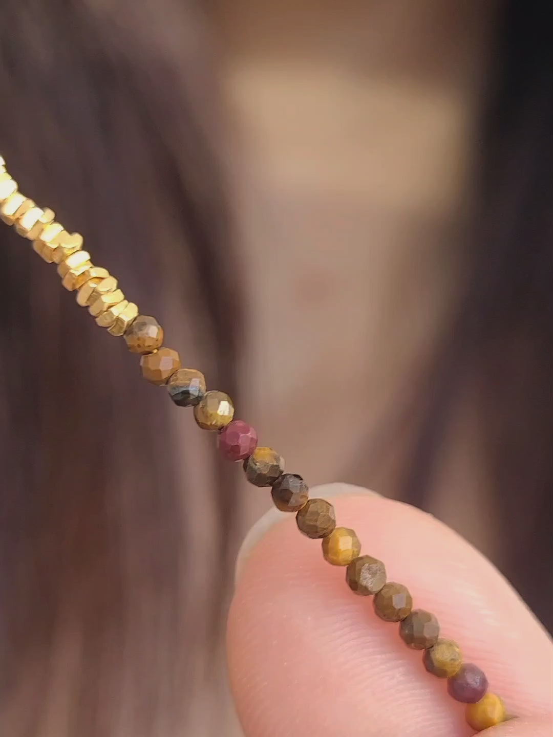 Model wearing a delicate Tiger's Eye Gemstone Necklace with Gold Vermeil Beads.