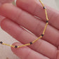 Close-up of a 22k gold vermeil choker necklace with black onyx beads worn around the neck. Crafted in 22k gold plated over sterling silver and natural gemstone. Perfect gift for mom.