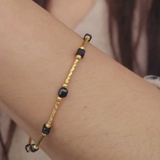 Close-up of a vintage-inspired Black tourmaline Bracelet featuring faceted black beads and textured gold vermeil bars on a wrist. Delicate and dainty bracelet gift for her.