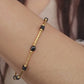 Close-up of a vintage-inspired Black tourmaline Bracelet featuring faceted black beads and textured gold vermeil bars on a wrist. Delicate and dainty bracelet gift for her.