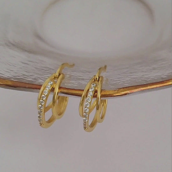 Showcasing a pair of Gold Triple Hoop Earrings.