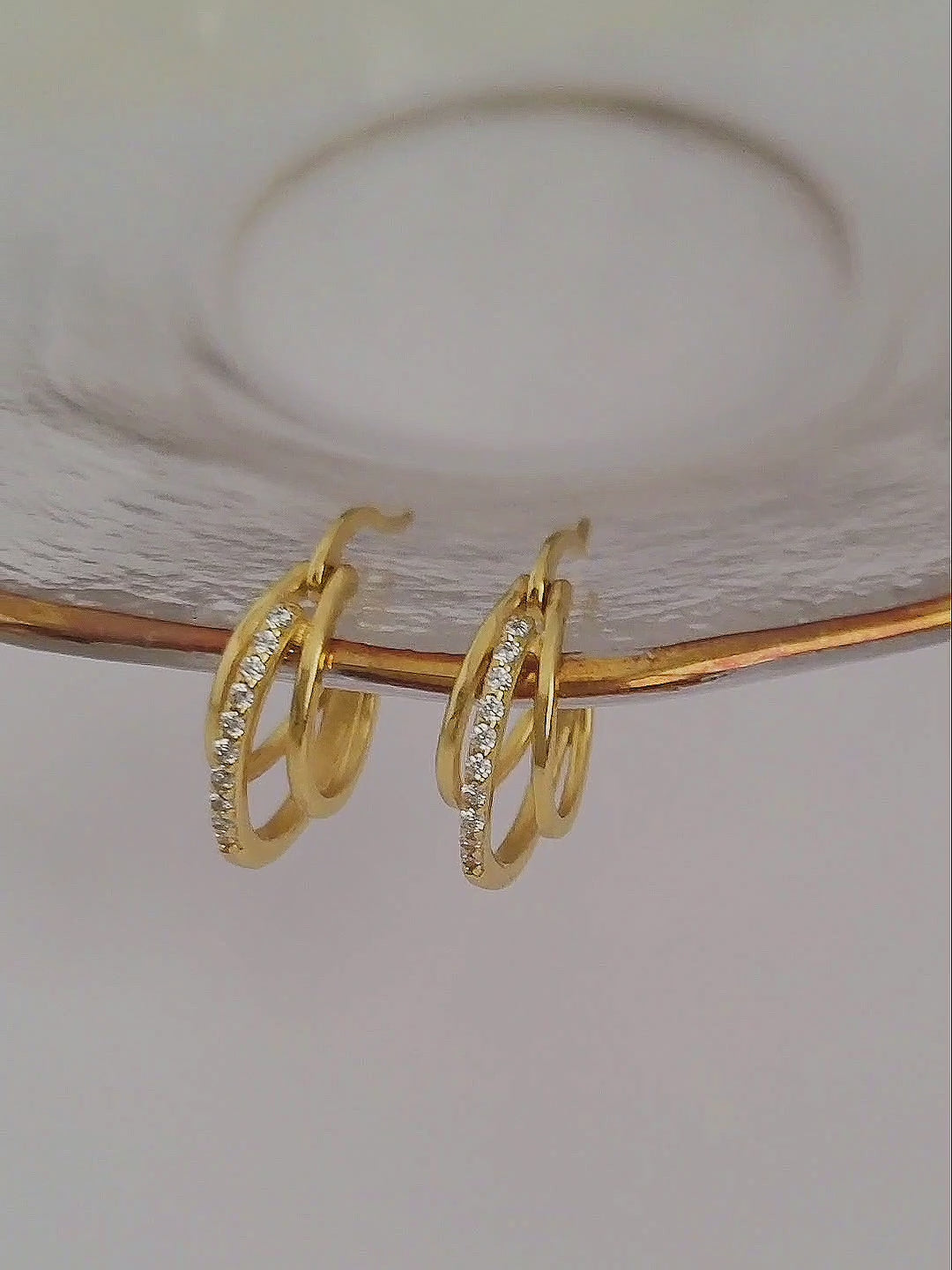 Showcasing a pair of Gold Triple Hoop Earrings.