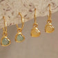 Woman wearing cute and dainty yellow heart dangle gold earrings, crafted in natural quartz crystal gemstone. Perfect anniversary gift for girl.
