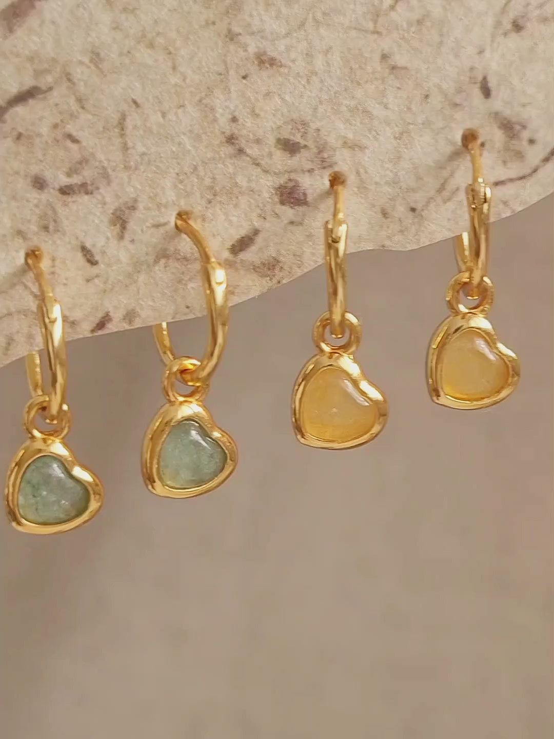 Woman wearing cute and dainty yellow heart dangle gold earrings, crafted in natural quartz crystal gemstone. Perfect anniversary gift for girl.