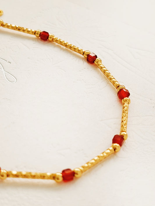 Close-up of a red onyx and gold beaded gemstone bracelet, featuring vintage-inspired elegance and dainty gold chain details. Crafted in gold plated sterling silver, perfect anniversary gift, birthday gift for her.
