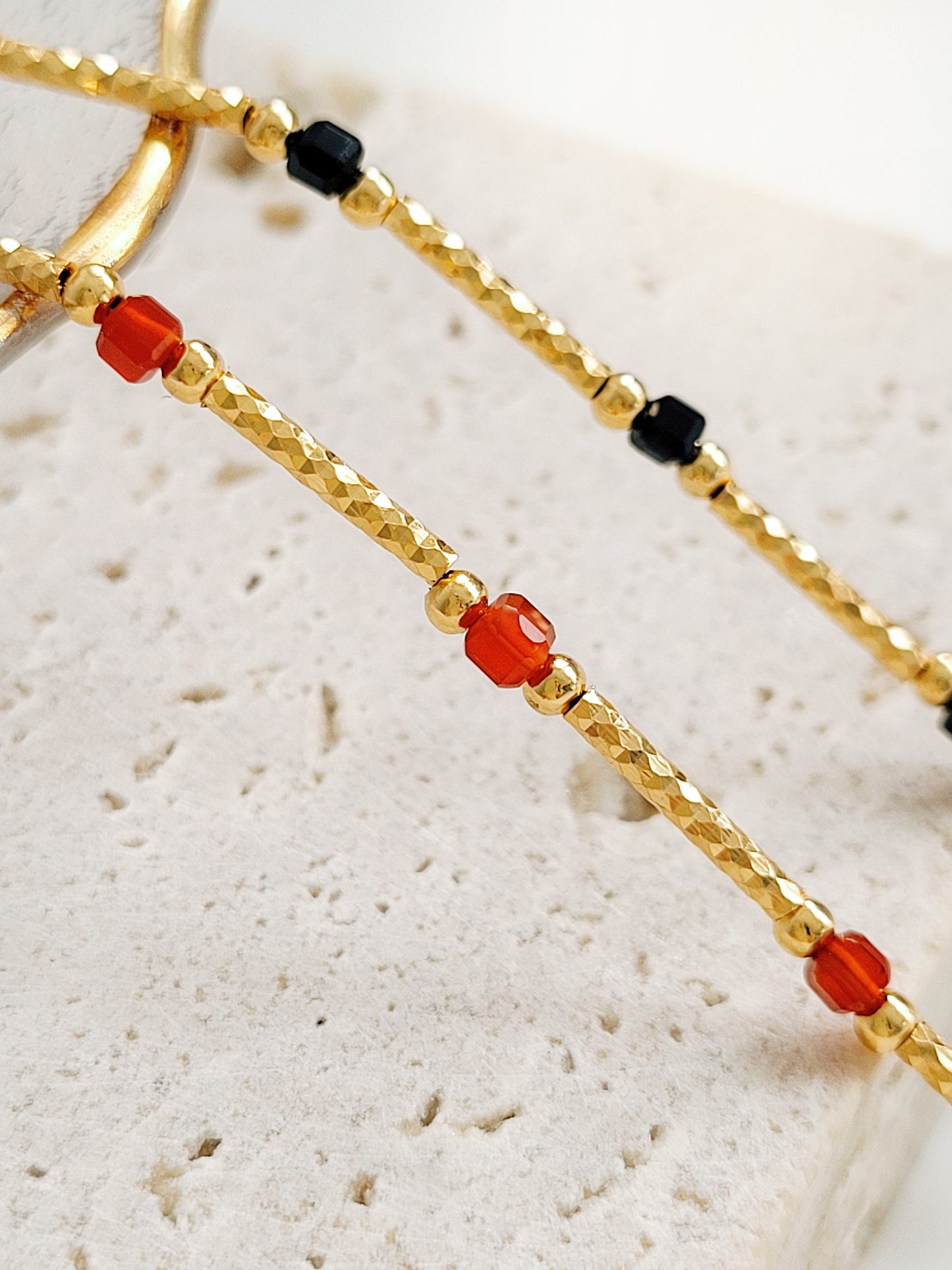 Close up of the details on red onyx gold necklace crafted in 22k gold vermeil.