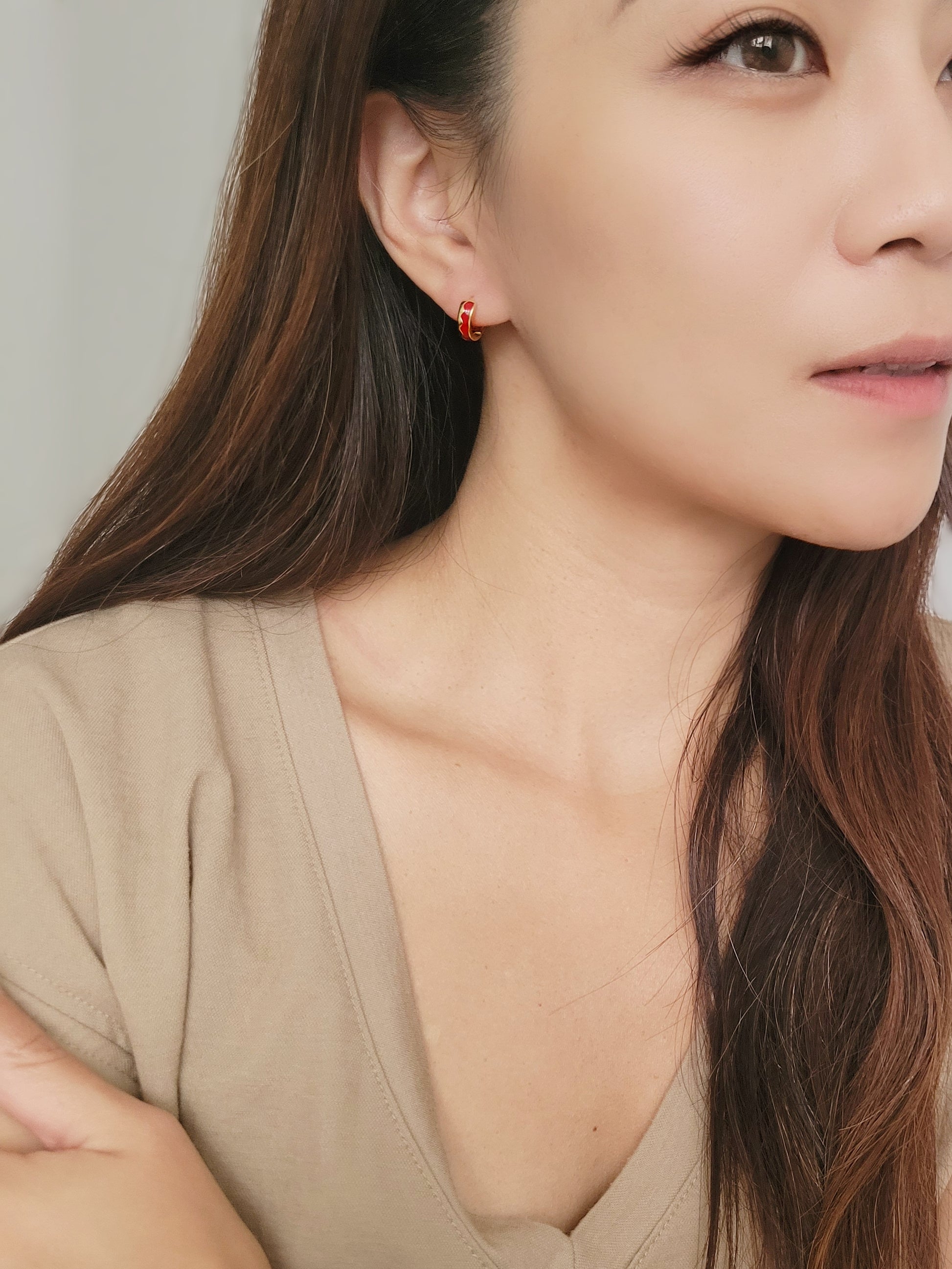 a beautiful woman wearing the Red Enamel Earrings in an elegant style