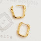 A pair of hammered gold-plated hoop earrings, showcasing a stylish and textured design perfect for any outfit.