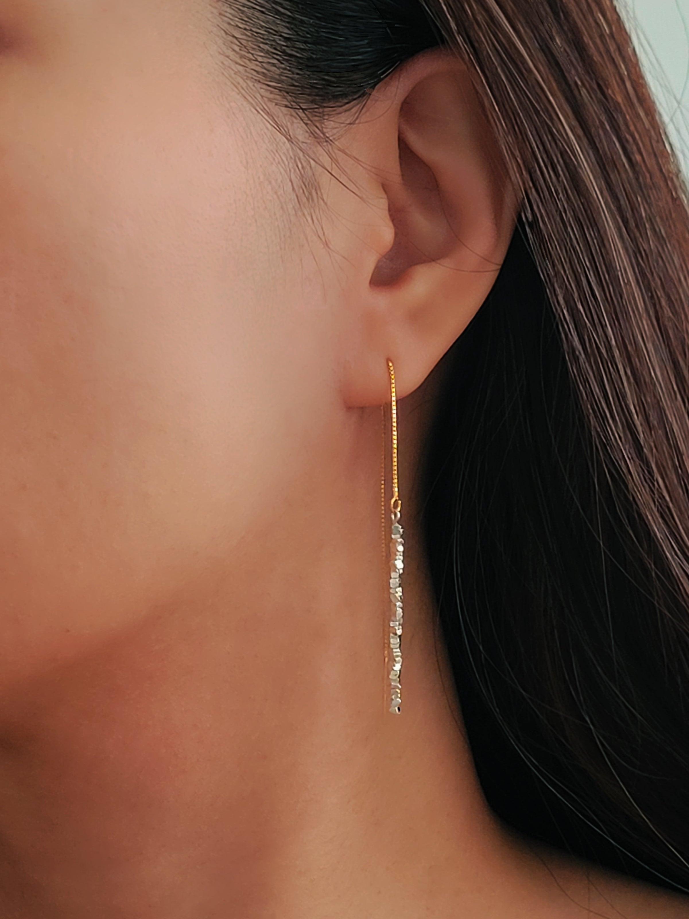 Woman wearing silver threader earrings with sterling silver nuggets, showing the long drop length. A unique London jewellery gift.