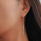 Woman wearing silver threader earrings with sterling silver nuggets, showing the long drop length. A unique London jewellery gift.