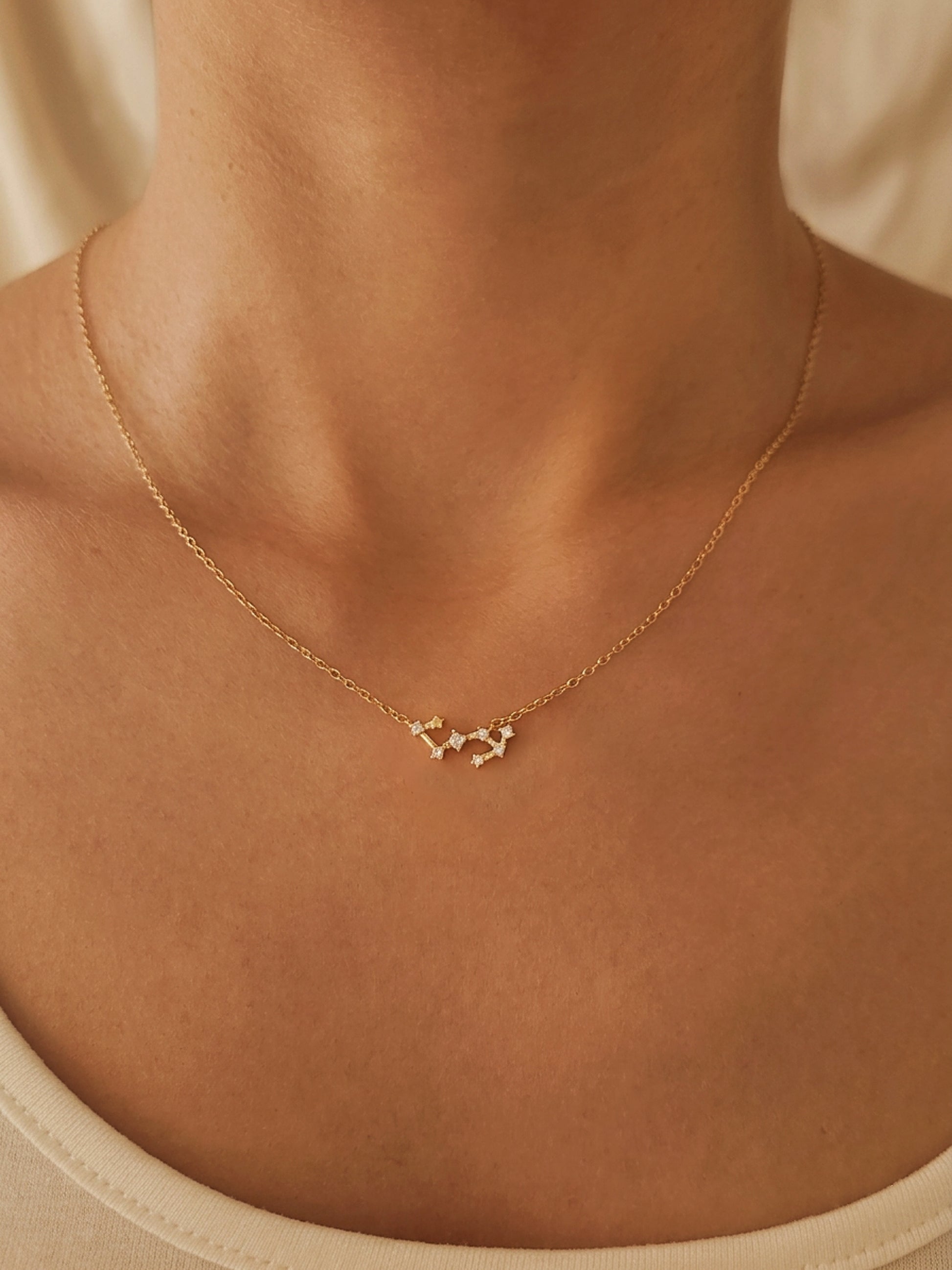 Close-up of a woman wearing a dainty gold Scorpio necklace showcasing the luxury aesthetic and pendant scale. Crafted in gold plated sterling silver, perfect jewellery gift for her.