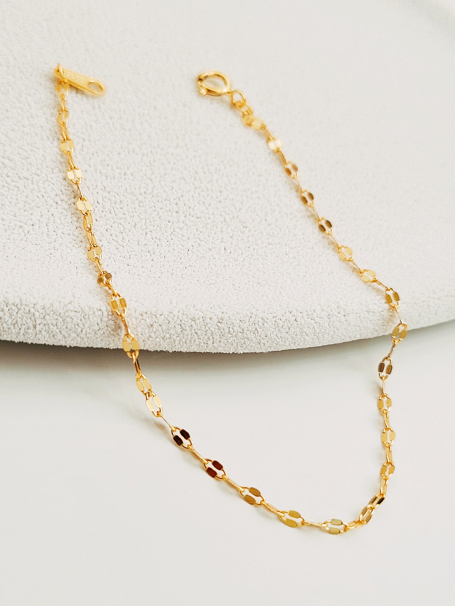 This dainty simple gold chain bracelet features a delicate and shimmering design. Finely crafted gold plated over sterling silver links create a minimalist yet elegant look.