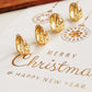 Gold star huggie earrings on a Christmas card with 'Merry Christmas & Happy New Year' text