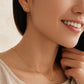 Close-up of a woman wearing a Taurus necklace and Taurus earring, showcasing the luxury aesthetic and pendant scale.