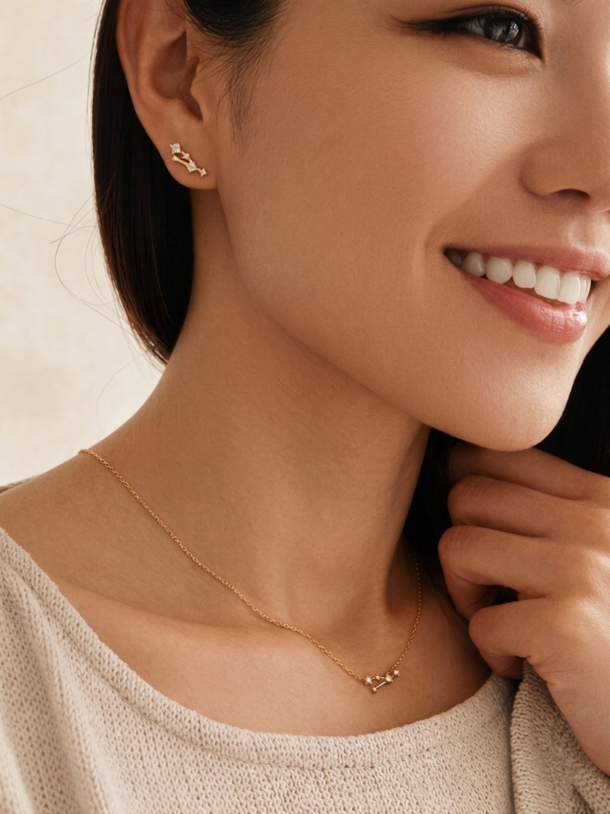 Close-up of a woman wearing a Taurus necklace and Taurus earring, showcasing the luxury aesthetic and pendant scale.