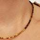 Close-up of woman wearing Tiger’s Eye gemstone choker necklace with 22K gold vermeil nugget beads 