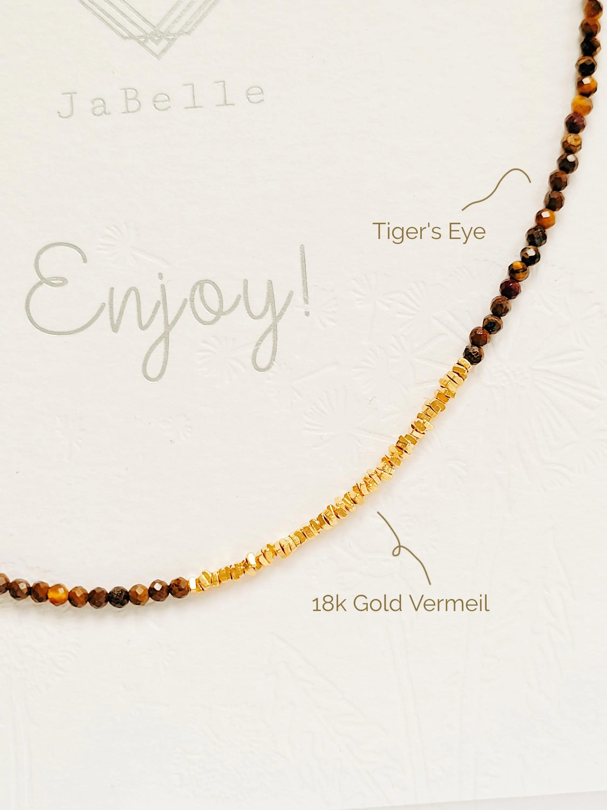 Necklace with tiger's eye and 18k gold vermeil on a white background, featuring the brand 'Jabelle'.