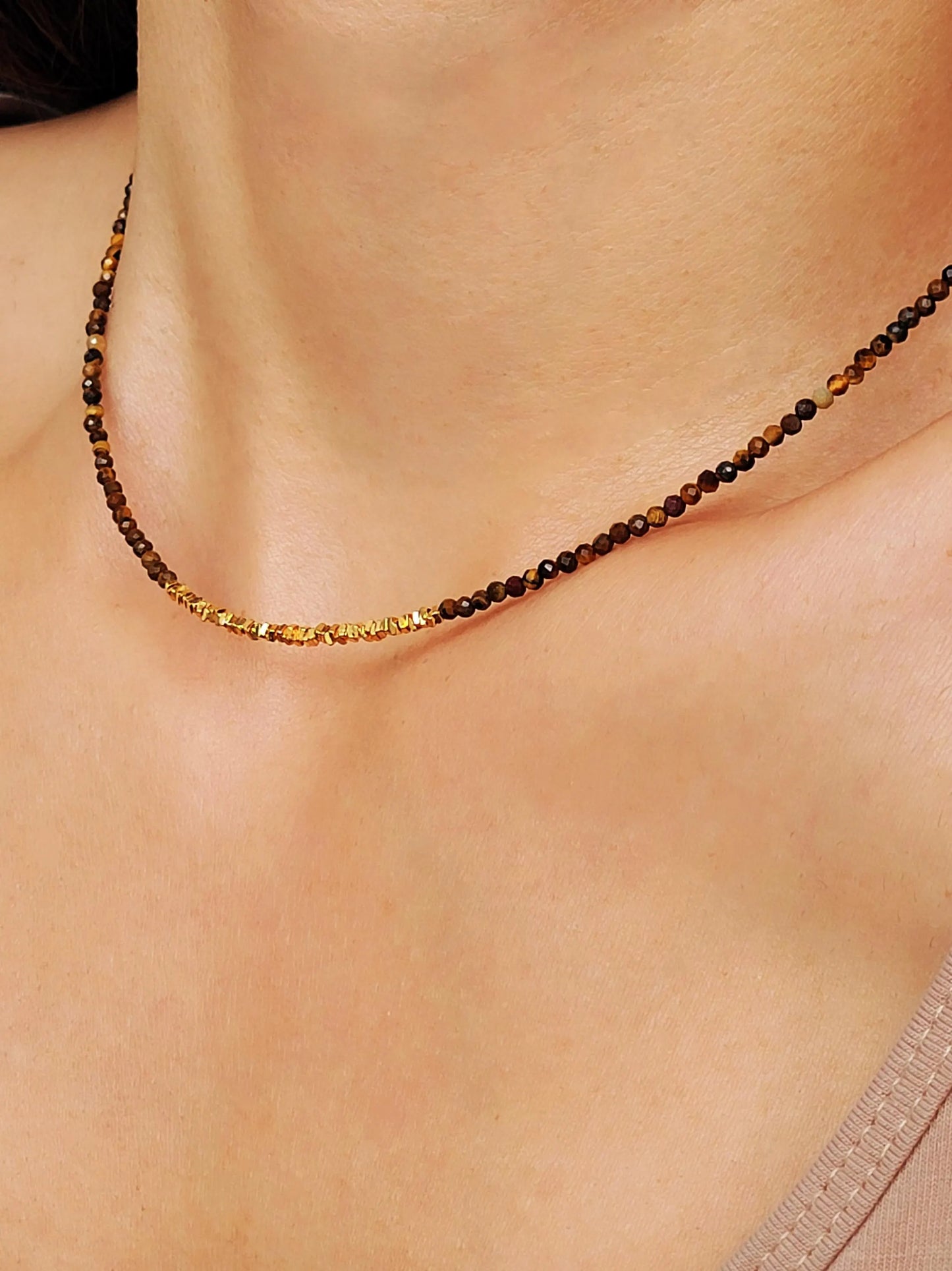 Model wearing a delicate Tiger's Eye Gemstone Necklace with Gold Vermeil Beads.