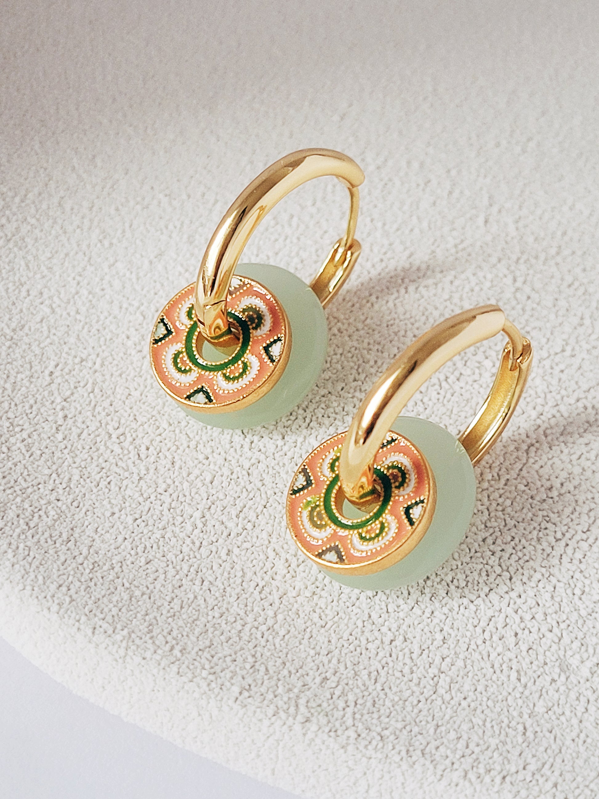 Elegant gold and green enamel hoop earrings featuring a stunning tile pattern, perfect for adding a touch of luxury to any ensemble.