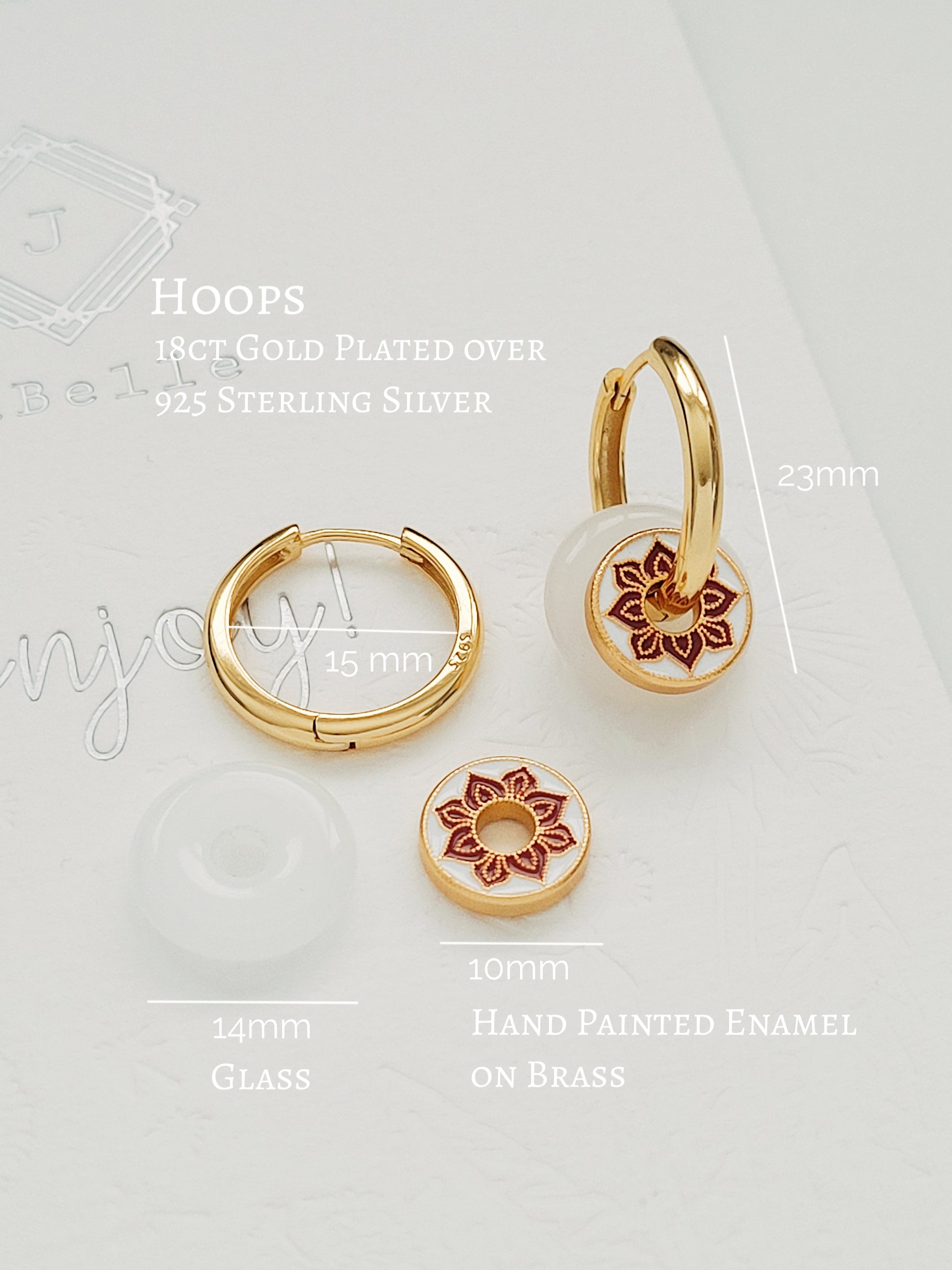 A pair of white jade and enamel disc hoop earrings, highlighting the art of vintage ceramic tile.