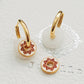 A pair of white jade and enamel disc gold hoop earrings, highlighting the art of vintage ceramic tile.