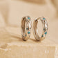 Close up of Turquoise star huggie hoop earring crafted in sterling silver, featuring a cosmic star inspired design. Minimalist earring design, perfect birthday gift for her.