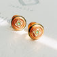 Beautiful gold earrings showcasing a unique tile pattern for a trendy accessory. Hand painted enamel with beige, green and white colour highlighting the detailed vintage tile pattern.