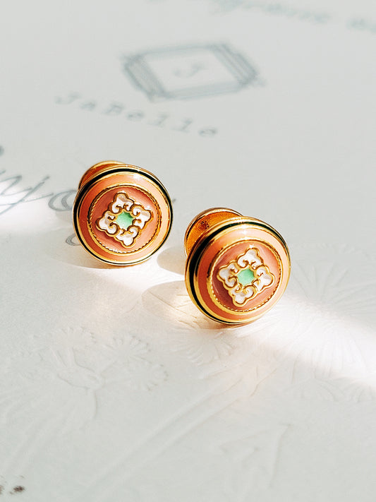 Beautiful gold earrings showcasing a unique tile pattern for a trendy accessory. Hand painted enamel with beige, green and white colour highlighting the detailed vintage tile pattern.