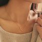 Close-up of a woman wearing a dainty gold Virgo necklace showcasing the luxury aesthetic and pendant scale. Crafted in gold vermeil, perfect jewellery gift for her.