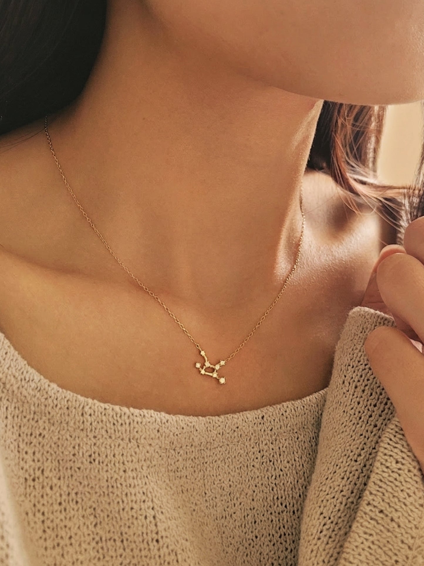 Close-up of a woman wearing a dainty gold Virgo necklace showcasing the luxury aesthetic and pendant scale. Crafted in gold vermeil, perfect jewellery gift for her.