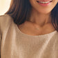 A woman wearing a Virgo necklace, showcasing the luxury aesthetic and pendant scale.