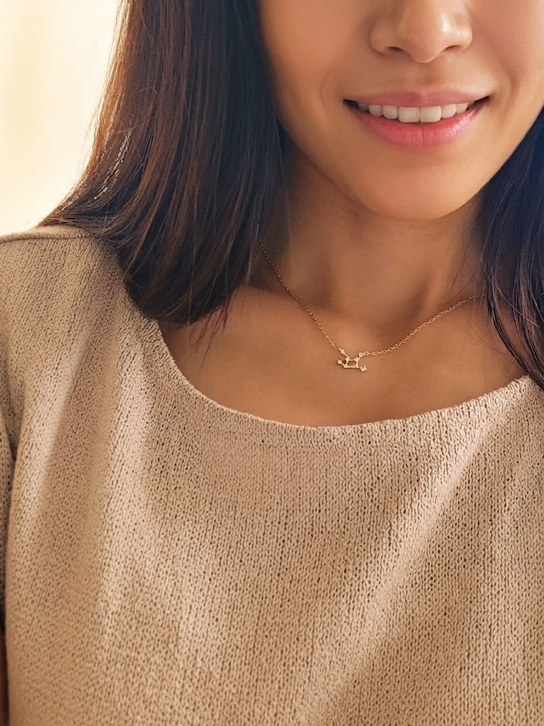 A woman wearing a Virgo necklace, showcasing the luxury aesthetic and pendant scale.
