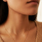 Close-up of a woman wearing a dainty gold Virgo necklace and Virgo earrings showcasing the luxury aesthetic and pendant scale. Crafted in gold vermeil, perfect jewellery gift for her.