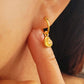 Heart huggie hoop earring worn on an ear, earrings are crafted in natural quartz gemstone and 18k gold plated sterling silver