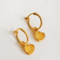 A pair of heart hoop earrings on a light gray background