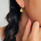 Woman wearing cute and dainty yellow heart dangle gold earrings, crafted in natural quartz crystal gemstone. Perfect anniversary gift for girl.