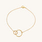 Stylish double-circle gold bracelet on a paper, highlighting its simple and timeless design, perfect for everyday wear or gifting.