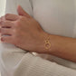 Delicate gold interlocking circle bracelet showcased on a wrist, highlighting its simple and timeless design, perfect for everyday wear or gifting