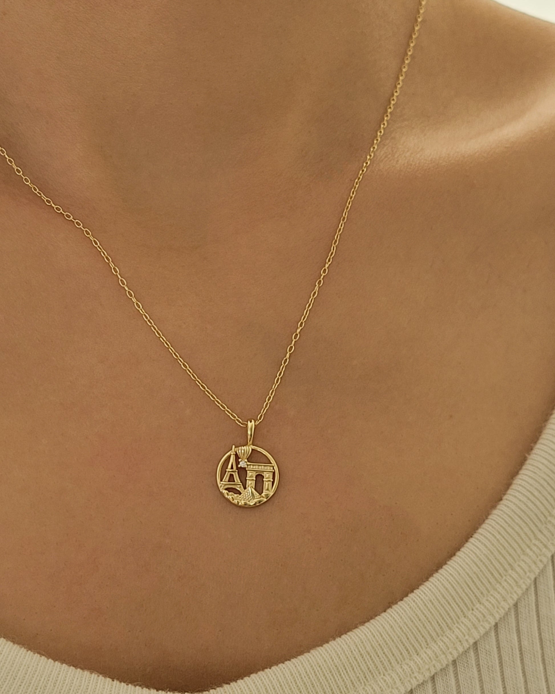 CLose up of a woman wearing paris necklace