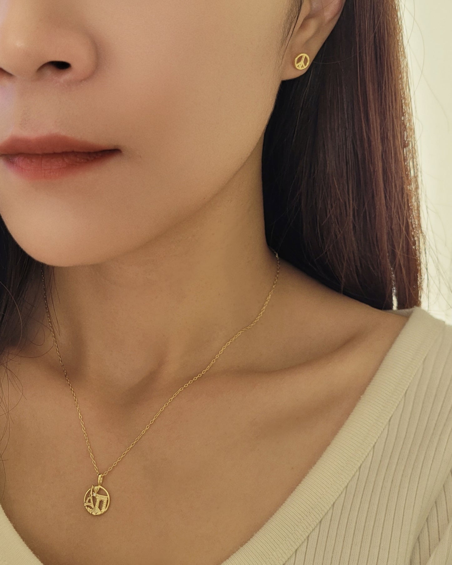 woman wearing paris necklace